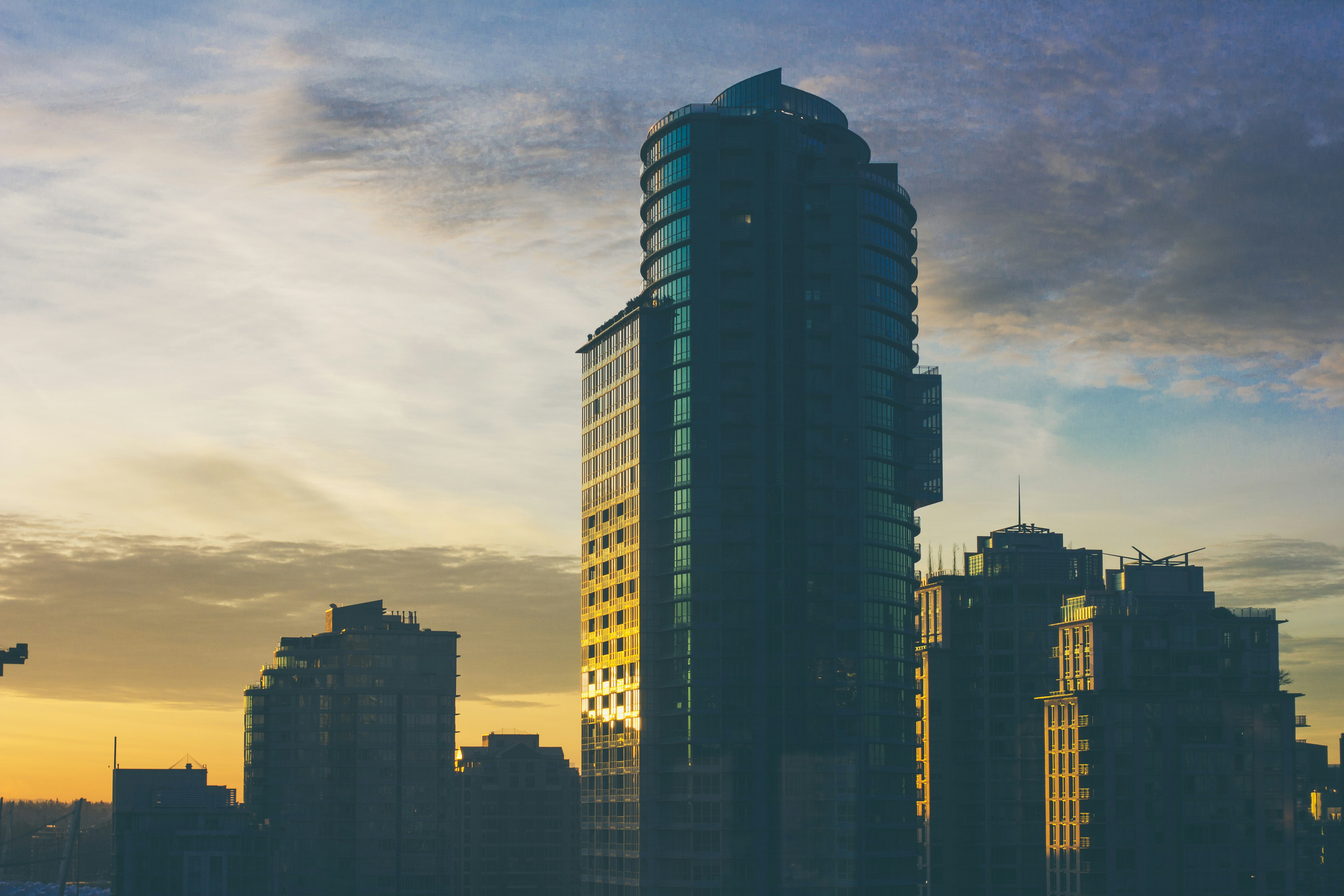 city buildings under cloudy sky during sunset